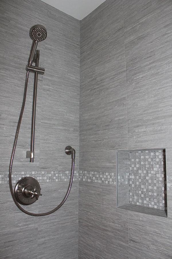 Gray Tiled Shower with Gray and White Glass Mosaic Border and Niche